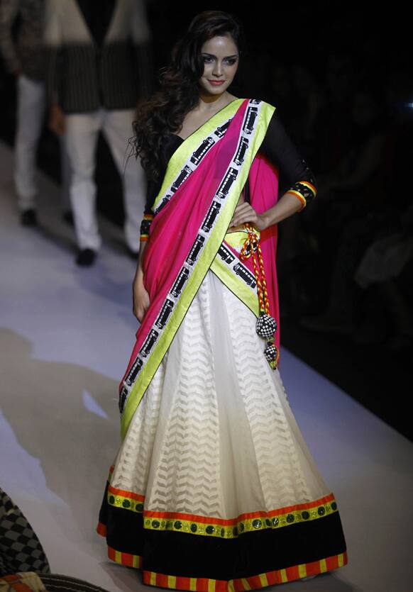 Bollywood actress Shajan Padamsee displays a creation by Archana Kochhar during the Lakme Fashion Week in Mumbai.