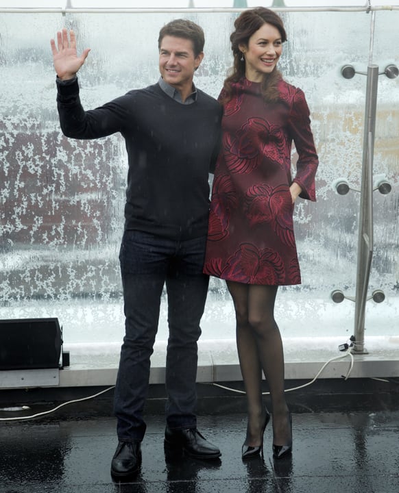 Hollywood actor Tom Cruise, left, and actress Olga Kurylenko pose during a photo call to promote their new movie Oblivion on the roof of a hotel in Moscow.