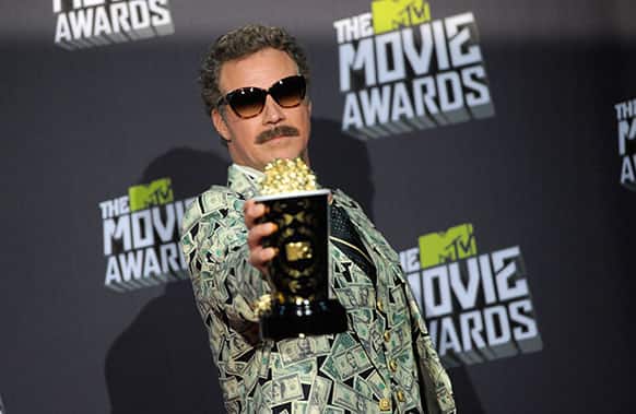 Will Ferrell poses with the comedic genius award backstage at the MTV Movie Awards in Sony Pictures Studio Lot in Culver City, Calif.