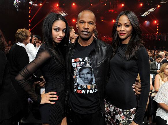 From left, Corinne Bishop and actors Jamie Foxx and Zoe Saldana pose in the audience at the MTV Movie Awards in Sony Pictures Studio Lot in Culver City, Calif.