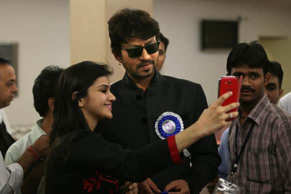 A girl gets a photograph taken with Irfan Khan during the National Film Awards 2012, in New Delhi. Khan was awarded the Best Actor.