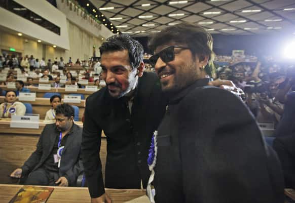 John Abraham hugs fellow actor Irfan Khan during the National Film Awards 2012, in New Delhi. Abraham's debut production