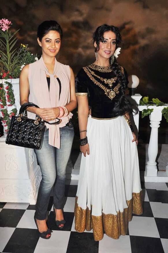 Newbie Meera Chopra (left) poses for the cameras with her co-actress Mahie Gill (right) during the mahurat of 'Gangs of Ghosts'.