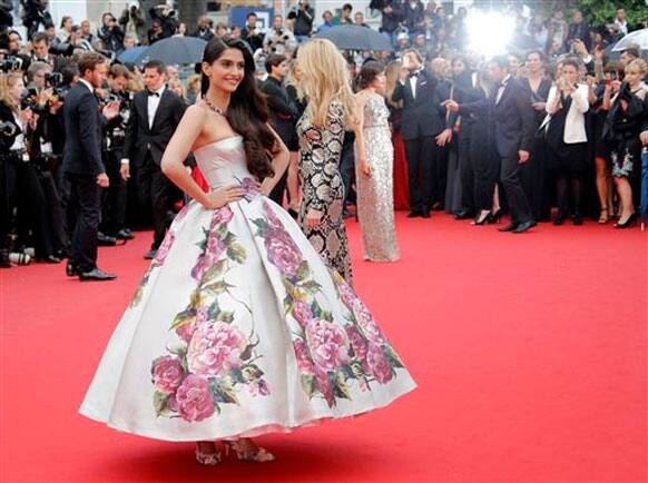 Sonam Kapoor poses for photographers as she arrives for the screening of Young & Beautiful at the 66th international film festival, wearing a Dolce & Gabbana floral print ball gown.