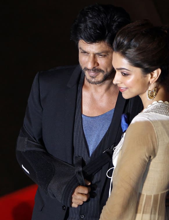 Shah Rukh Khan poses with co actor Deepika Padukone during the release of the trailer of his upcoming movie 