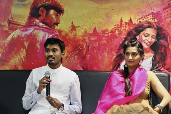 Dhanush, answers a question as actress Sonam Kapoor watches during a press conference to promote their new movie “Raanjhnaa” in Ahmadabad. The film will be released in India on June 21.