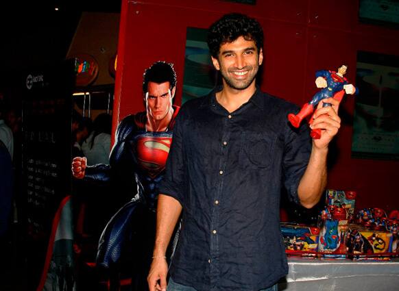 Aditya Roy Kapur poses with a Superman miniature.