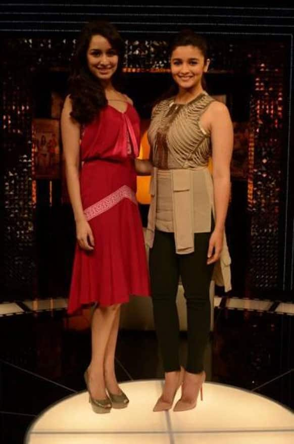 Pretty women Alia Bhatt and Shraddha Kapoor pose for the camera on the sets of a chat show.