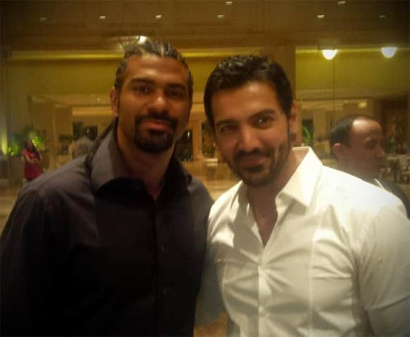 John Abraham poses for a photograph with renowned boxer David Haye.