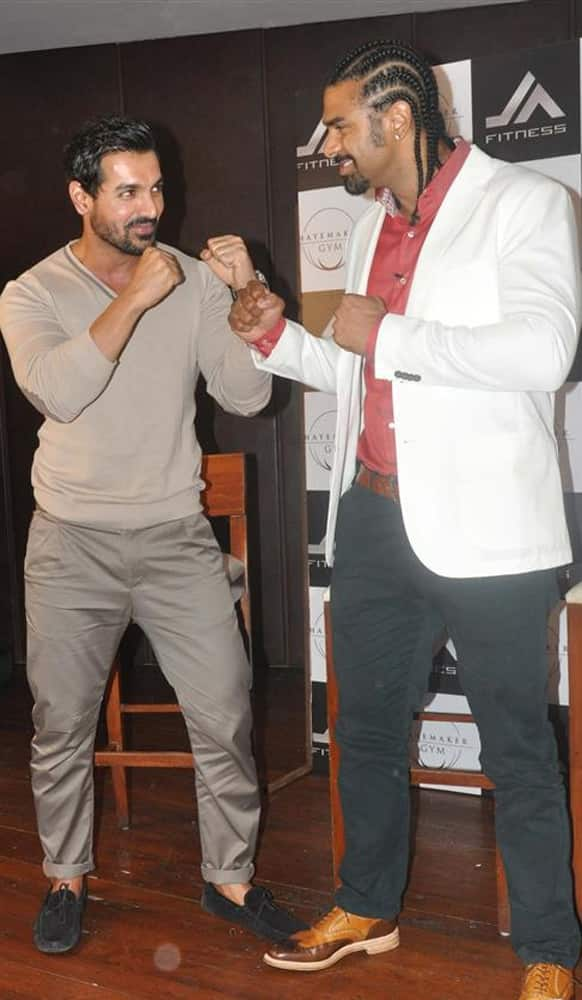 John Abraham in a friendly boxing pose with renowned boxer David Haye.