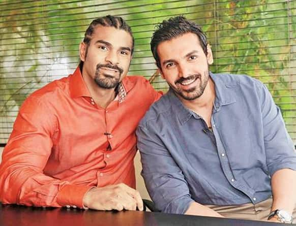 John Abraham poses for a photograph with renowned boxer David Haye.