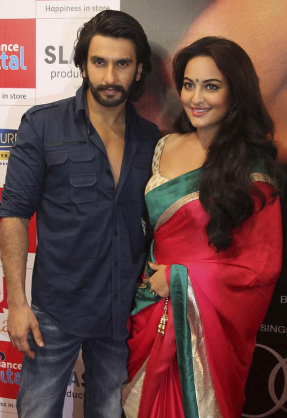 Sonakshi Sinha and Ranveer Singh pose for photographs during a press conference to promote their upcoming movie Lootera in Ahmadabad.