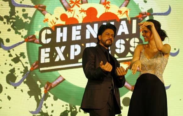 Shah Rukh Khan dances with co actor Deepika Padukone during the music release for his upcoming movie 