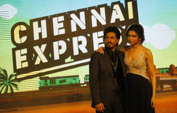 Shah Rukh Khan posses for a picture with co actor Deepika Padukone during the music release for his upcoming movie 