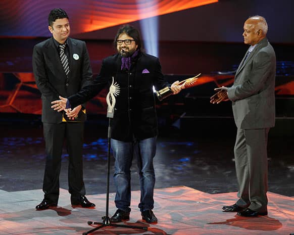 Bollywood's Pritam Chakraborty receives the award for Background Score during the International Indian Film Academy (IIFA) awards in Macau.