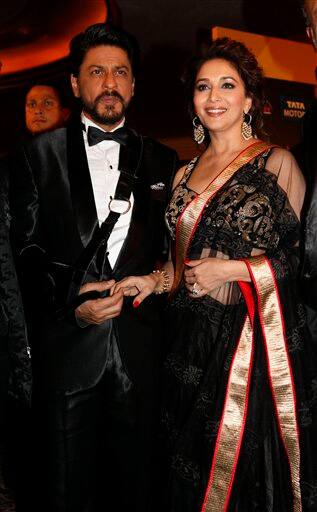 Shah Rukh Khan and Madhuri Dixit arrive for the International Indian Film Academy (IIFA) awards in Macau, Saturday, July 6, 2013.