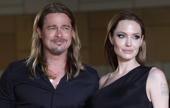 Brad Pitt with Angelina Jolie poses for photographers upon arrival for the Japan premiere of his latest film 