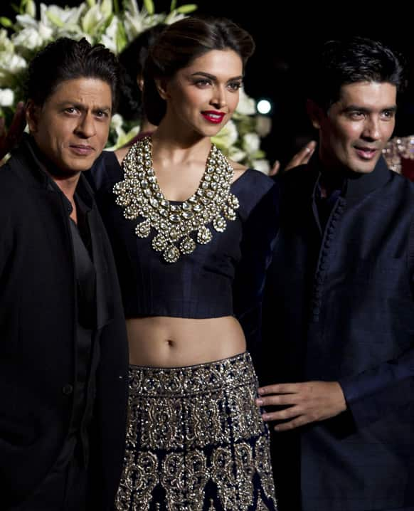 Bollywood actors Sharuk Khan, Deepika Padukone and Indian designer Manish Malhotra walk at the ramp, during the Delhi Couture Week.