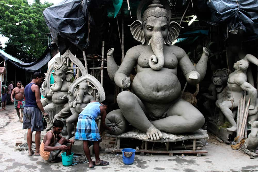 Artisans make clay idols of the elephant-headed Hindu God Ganesha ahead of the Ganesh Chaturthi festival in Kolkata.