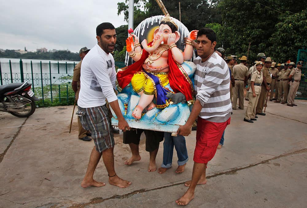 Worshippers carry an idol of elephant-headed Hindu god Ganesha for immersion in a pond during Ganesh Chaturthi festival celebrations in Bangalore.