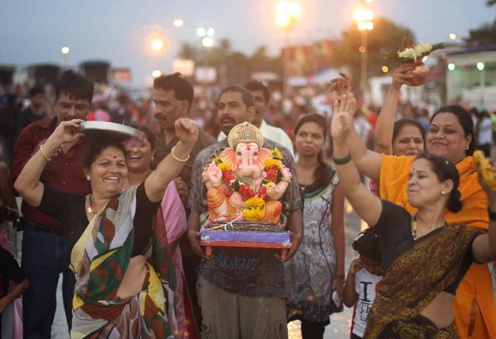 Devotees dance as they prepare to immerse an idol of elephant-headed Hindu god Ganesha in the Arabian Sea during Ganesh Chaturthi festival celebrations in Mumbai.