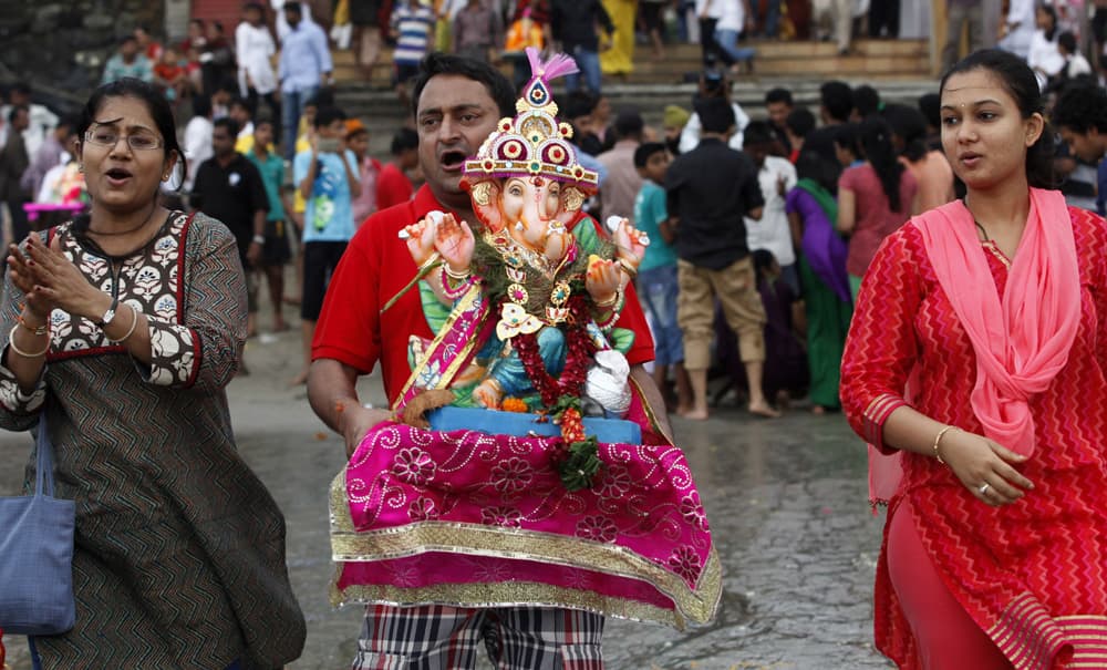 Devotees prepare to immerse an idol of elephant-headed Hindu god Ganesha in the Arabian Sea during Ganesh Chaturthi festival celebrations in Mumbai.