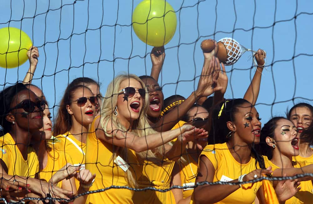 Miss World Pageant contestants cheer their team during a beach game in Nusa Dua, Bali, Indonesia.