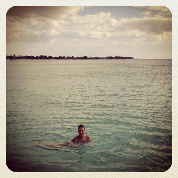 Neha Dhupia enjoying a swim in the sea during her holiday.