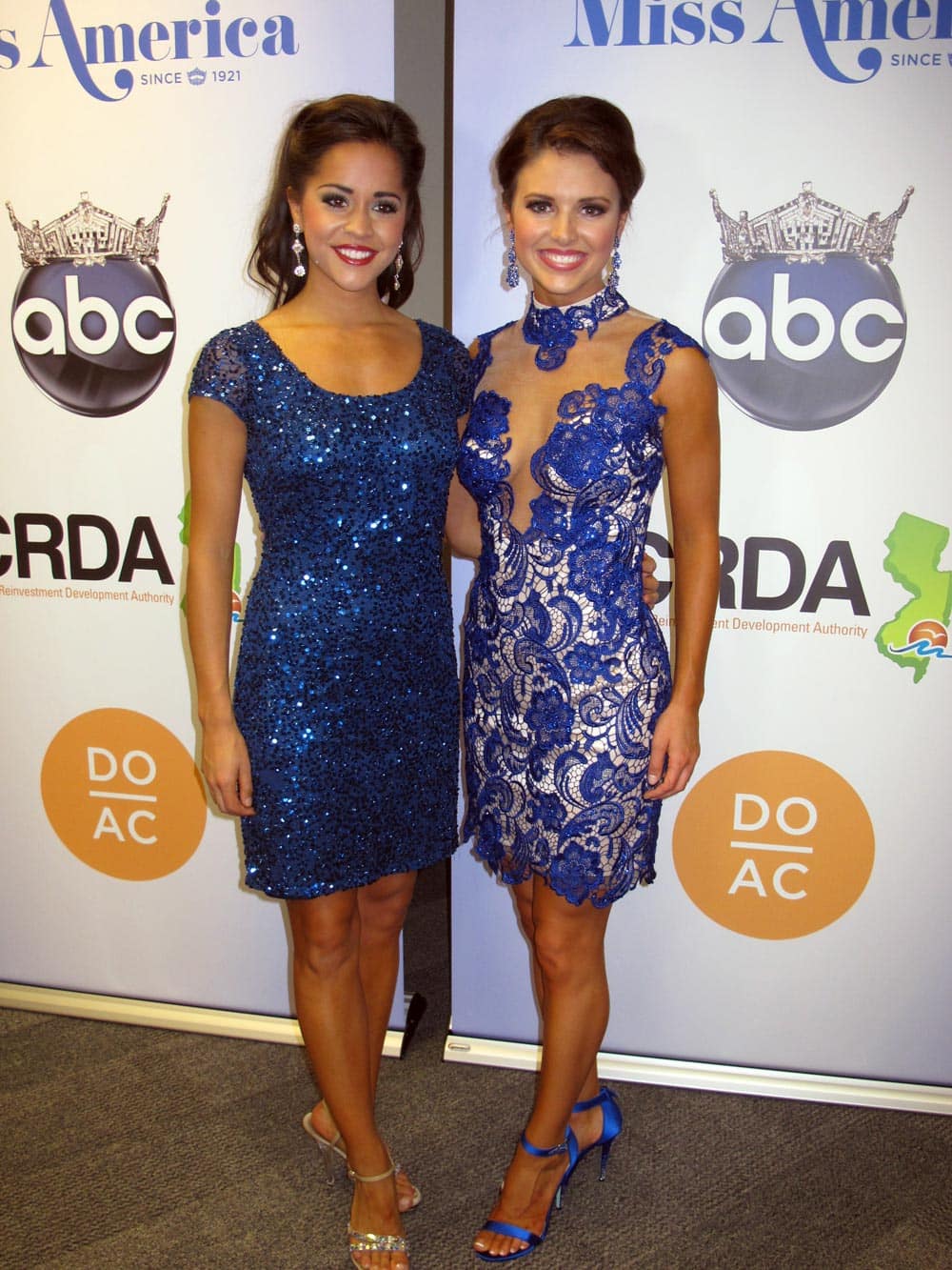 Miss Minnesota Rebecca Yeh and Miss Oklahoma, Kelsey Griswold, pose for photographers on Sept.11, 2013 after winning the second night of preliminary competition in the Miss America pageant.