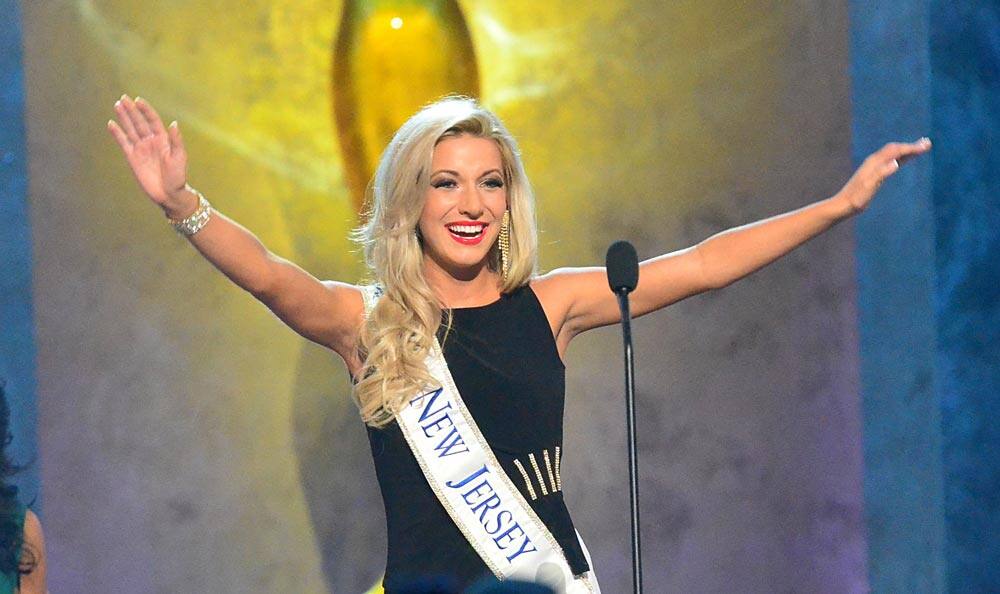 Miss New Jersey, Cara McCollum, waves during the preliminary competition of the Miss America Pageant at Boardwalk Hall, in Atlantic City.