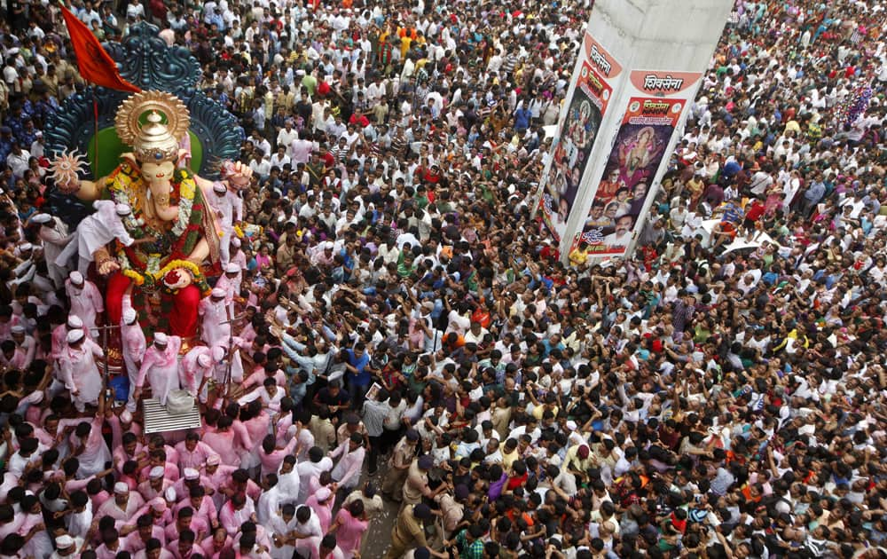 Devotees take an idol of Hindu god Ganesha through a street for immersion in the Arabian Sea in Mumbai.