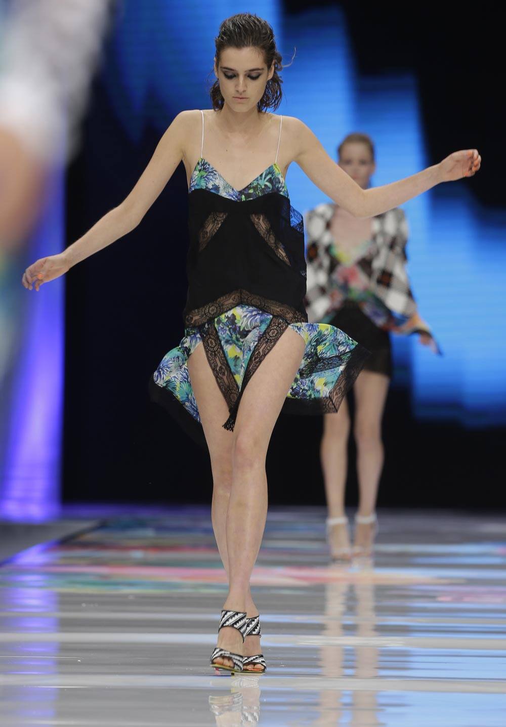 A model loses her balance on the catwalk as she wears a creations for Just Cavalli women's Spring-Summer 2014 collection, part of the Milan Fashion Week.