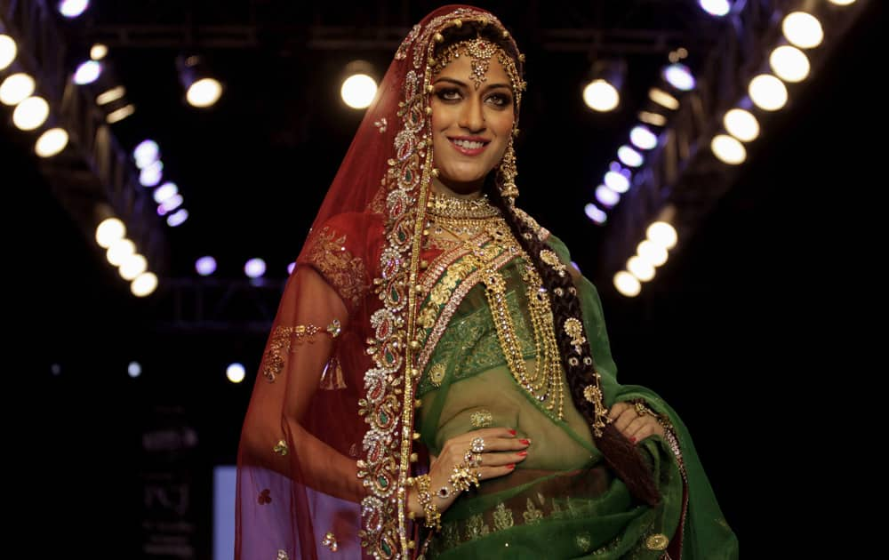 A model displays a creation by “Cher Style Check” during the India Jewellery and Fashion Week (IJFW) in Ahmadabad.