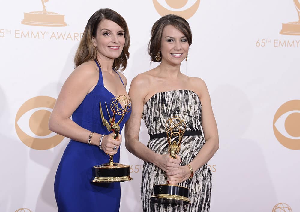 Tina Fey, left, and Tracey Wigfield pose backstage with the award for outstanding writing for a comedy series for their work on “30 Rock” at the 65th Primetime Emmy Awards at Nokia Theatre.