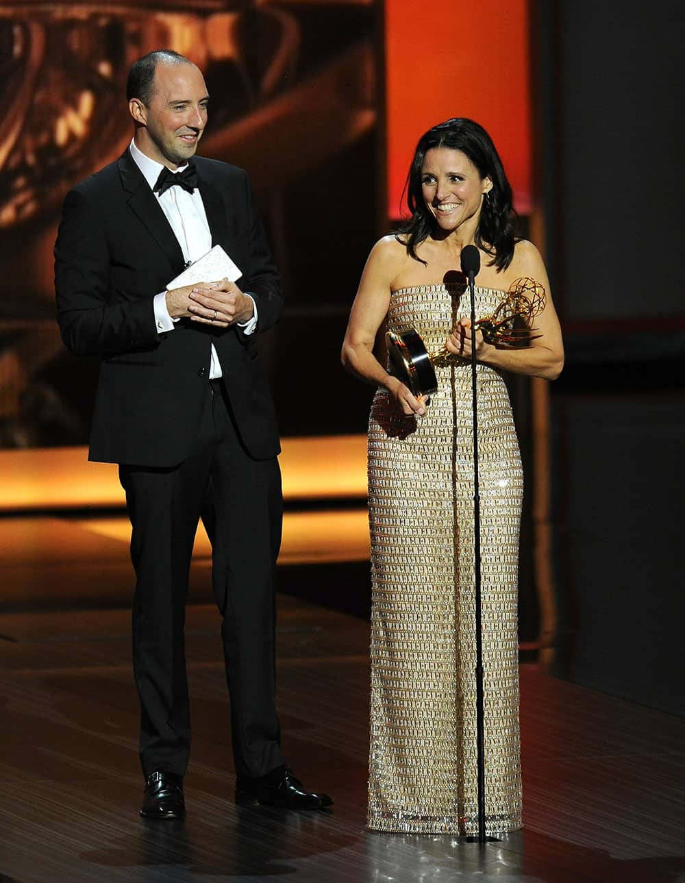 Tony Hale, left, looks on as Julia Louis-Dreyfus accepts the award for outstanding lead actress in a comedy series for her role on “Veep” at the 65th Primetime Emmy Awards at Nokia Theatre.