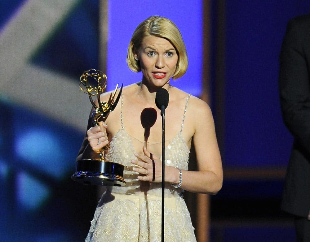 Claire Danes accepts the award for outstanding lead actress in a drama series for her role on “Homeland” as presenter Jimmy Fallon looks on at right at the 65th Primetime Emmy Awards at Nokia Theatre.