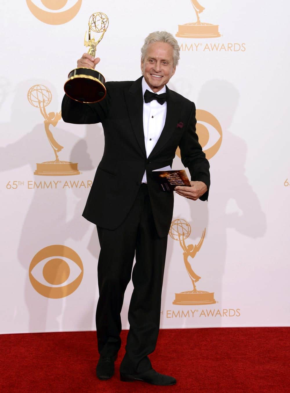 Michael Douglas, winner of the Best Lead Actor in a Miniseries or Movie Award for 'Behind The Candelabra' poses backstage at the 65th Primetime Emmy Awards at Nokia Theatre.