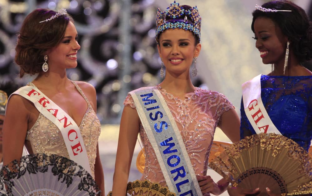 Newly crowned Miss World, Megan Young of Philippines with second runner-up Miss France Marine Lorpheline, left, and third runner-up Miss Ghana Carranza Naa Okailey Shooter, smile after they winning the Miss World contest in Nusa Dua, Bali, Indonesia.