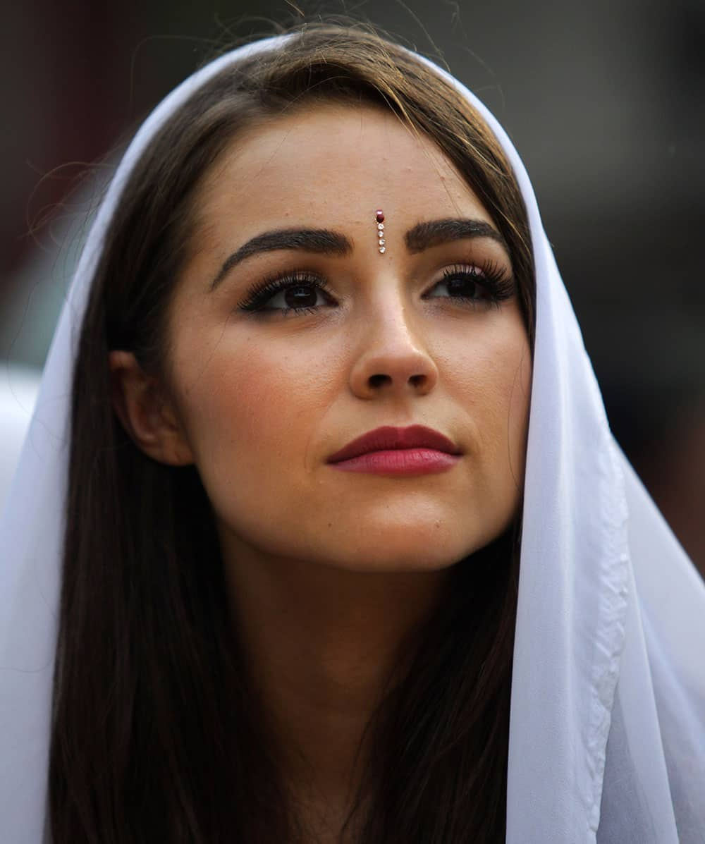 Miss Universe, Olivia Culpo of the USA, watches a performance by inmates during a visit to the Tihar Jail in New Delhi.