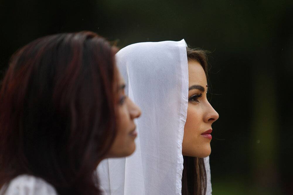 Miss Universe Olivia Culpo, right, watches a performance by inmates during a visit to the Tihar Jail in New Delhi.