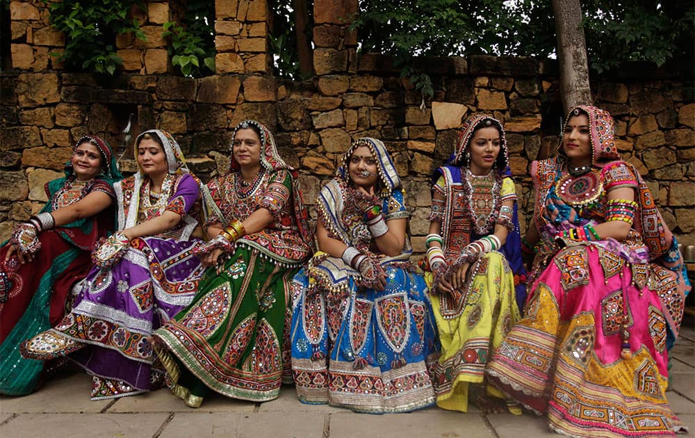 Women dressed in traditional finery watch others practice the Garba dance ahead of the Navratri festival in Ahmadabad.