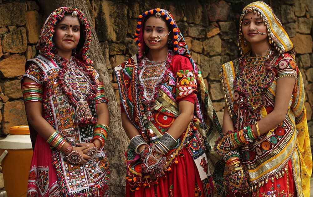 Women dressed in traditional finery watch others practice the Garba dance ahead of the Navratri festival in Ahmadabad.