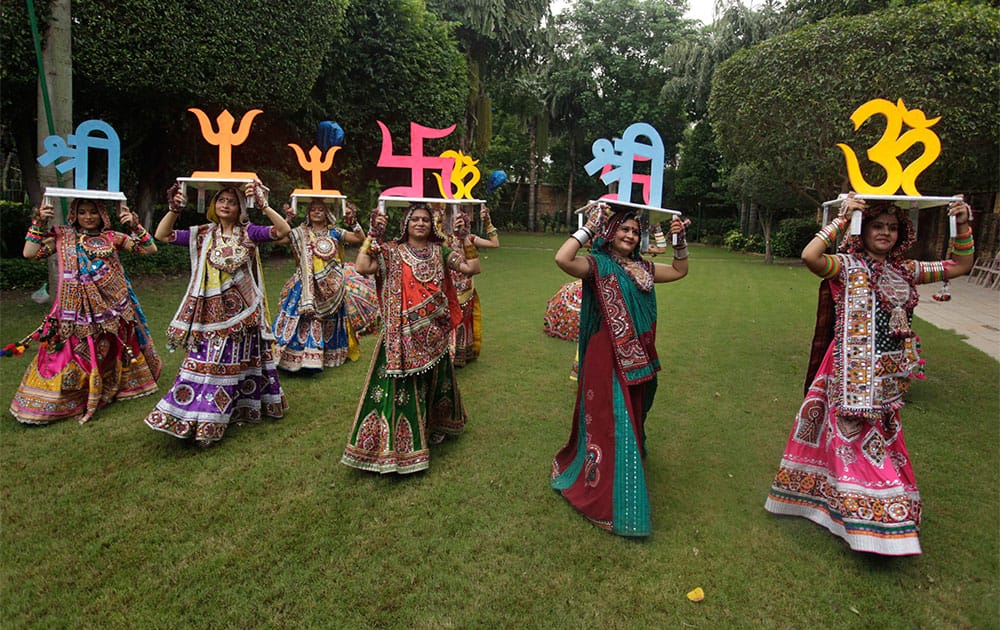 Women dressed in traditional finery carry religious symbols on their heads as they practice the Garba dance ahead of the Navratri festival in Ahmadabad.