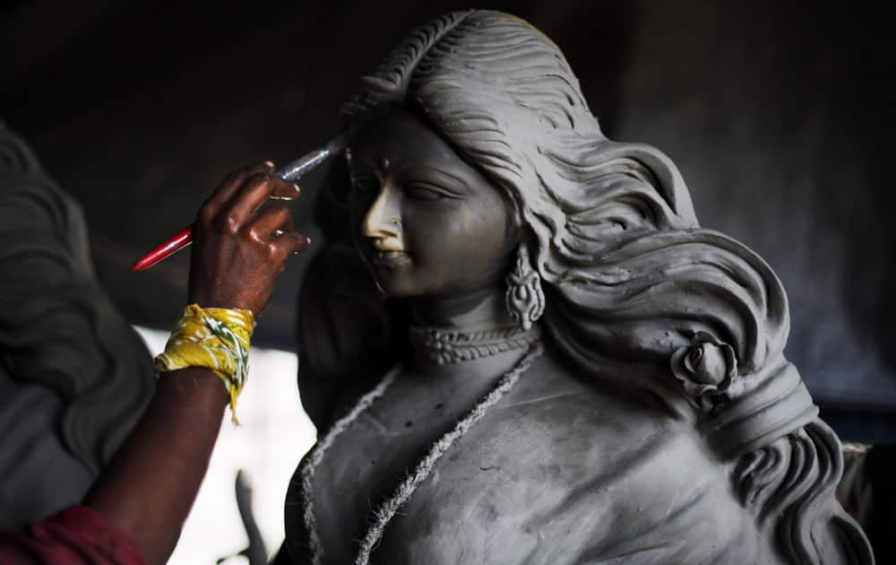 Artist prepares an idol of Hindu goddess Durga ahead of Durga Puja festival in New Delhi.