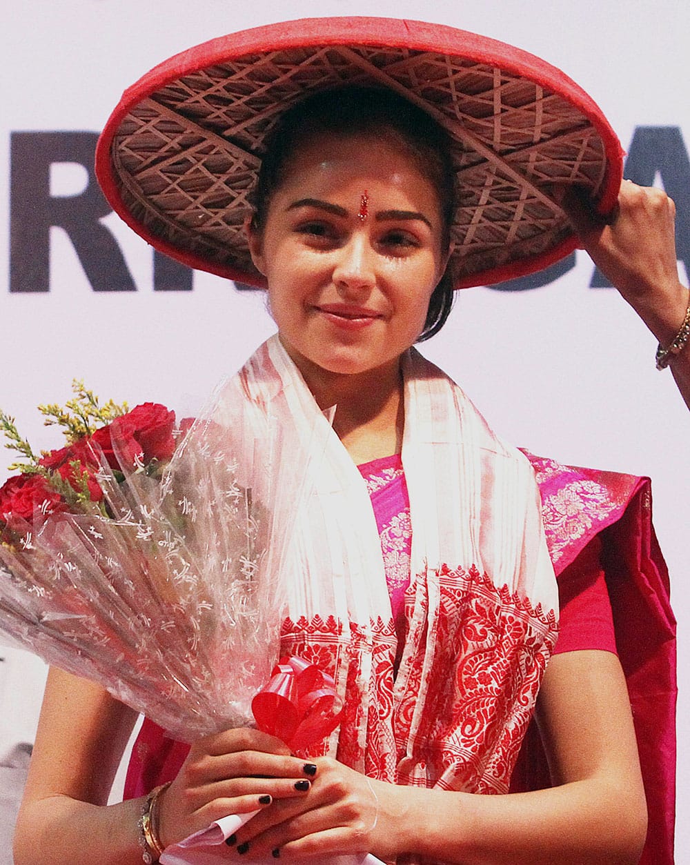 Miss Universe Olivia Culpo wears a traditional Assamese hat called Japi during a campaign 