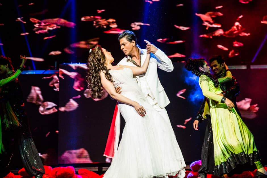 Shah Rukh Khan romances Madhuri Dixit during a performance at the TEMPTATIONS RELOADED 2013 event in Sydney.