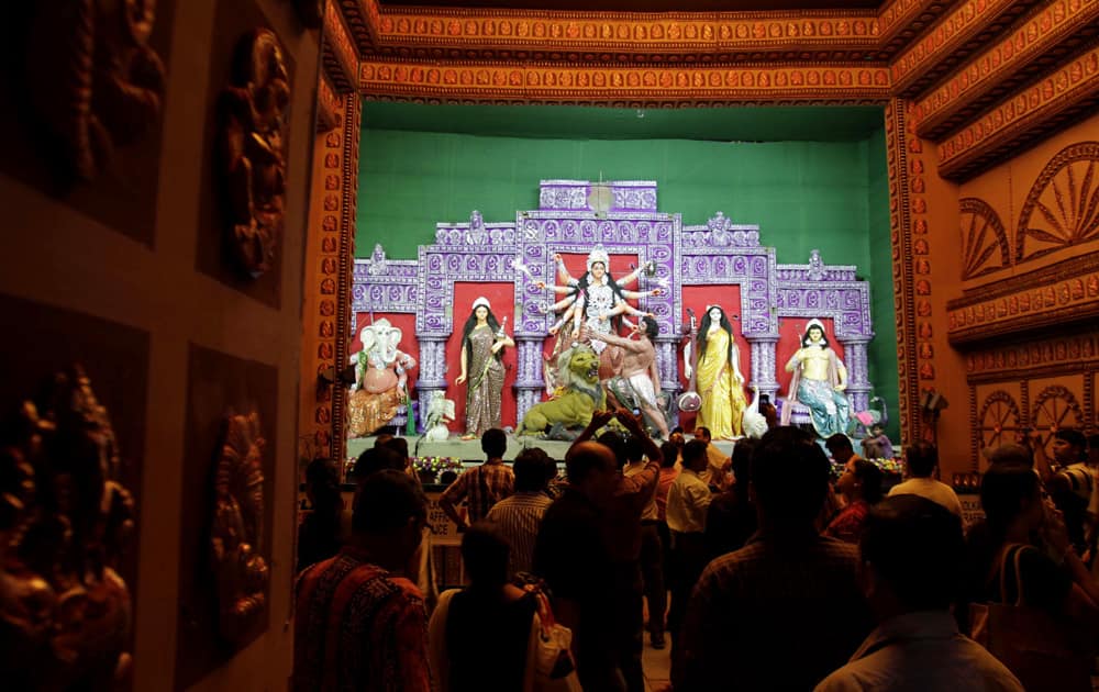 People gather at a makeshift worship venue for Hindu goddess Durga in Kolkata.