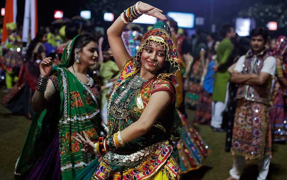 A woman dressed in traditional finery performs the Garba dance of the Navratri festival in Ahmadabad.