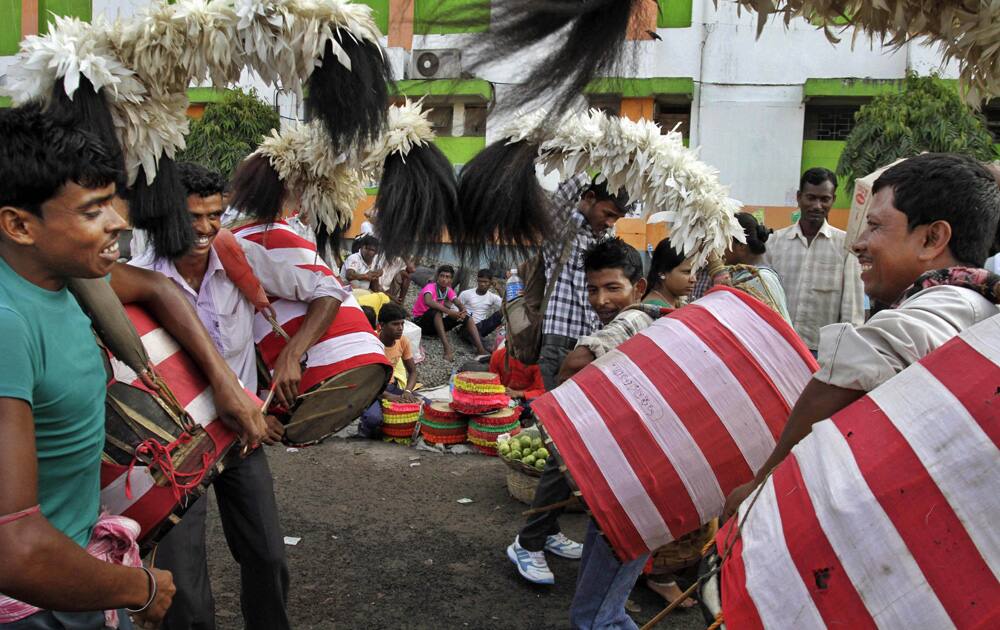 A group of traditional drum players perform as they wait to be hired by the organizers of Durga Puja venues in Kolkata.