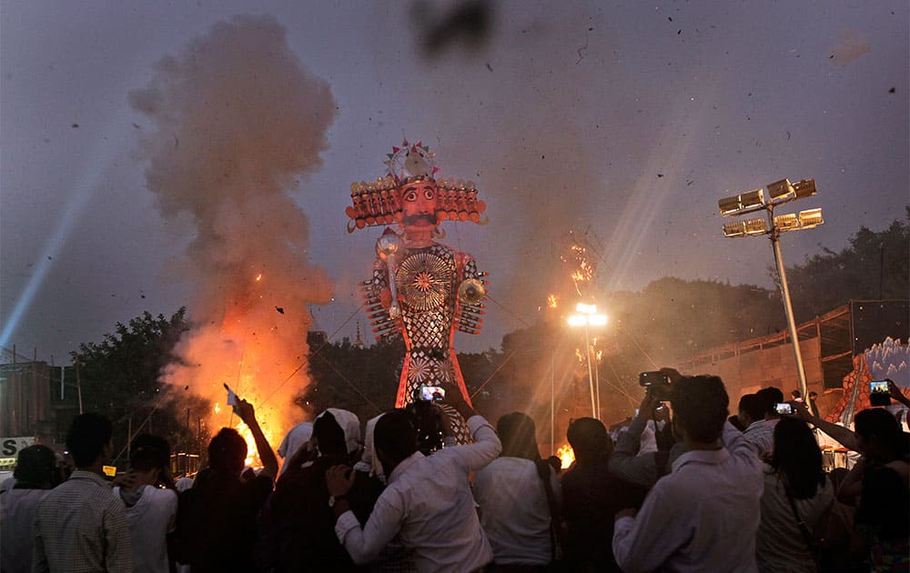 People watch as effigies of the ten-headed demon king Ravana and his brothers are burned during Dussehra celebrations in New Delhi.